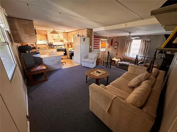 a living room with furniture a couch and a window