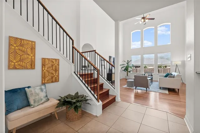 a living room with couches and dining table with wooden floor