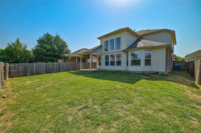 a view of a house with a yard and sitting area
