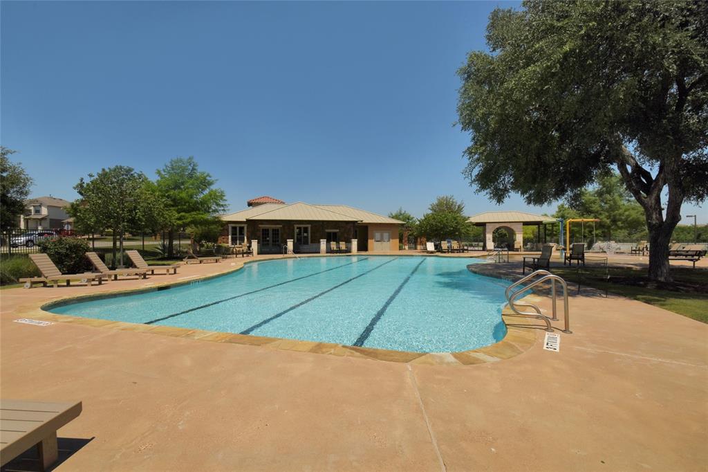3664 Rosalina Loop Round Rock, TX 78665 - Photo 22 of 22 a view of a yard with table and chairs under an umbrella