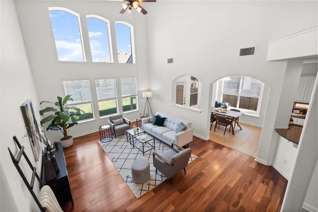 a living room with furniture dining table and wooden floor