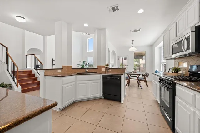 a kitchen with a sink stove and cabinets
