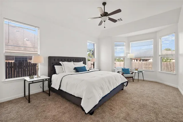 a bed room with a bed and a chair