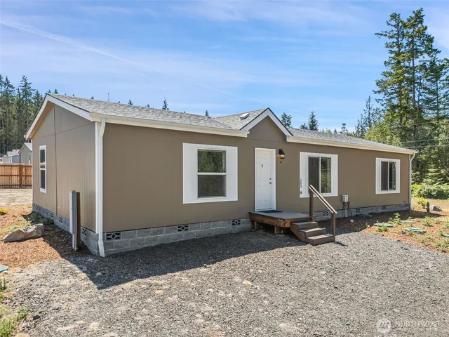 a view of a house with backyard porch and sitting area