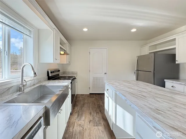 a kitchen with a refrigerator and a sink