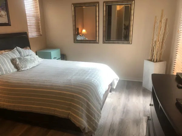 a bathroom with a granite countertop toilet and a sink