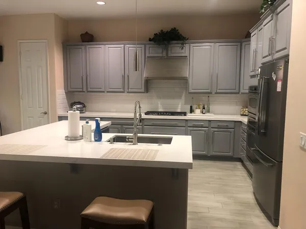 a kitchen with a sink stove and cabinets