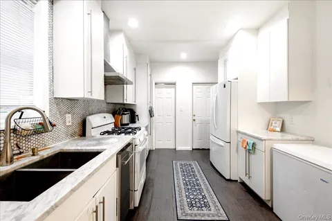 a kitchen with a sink stove and refrigerator