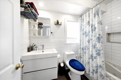 a bathroom with a sink a toilet and a mirror