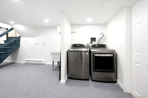 a view of a kitchen with a stove wooden cabinets and a refrigerator