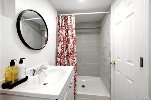 a bathroom with a sink a mirror and a bathtub