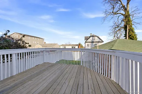 a view of balcony with wooden floor and fence