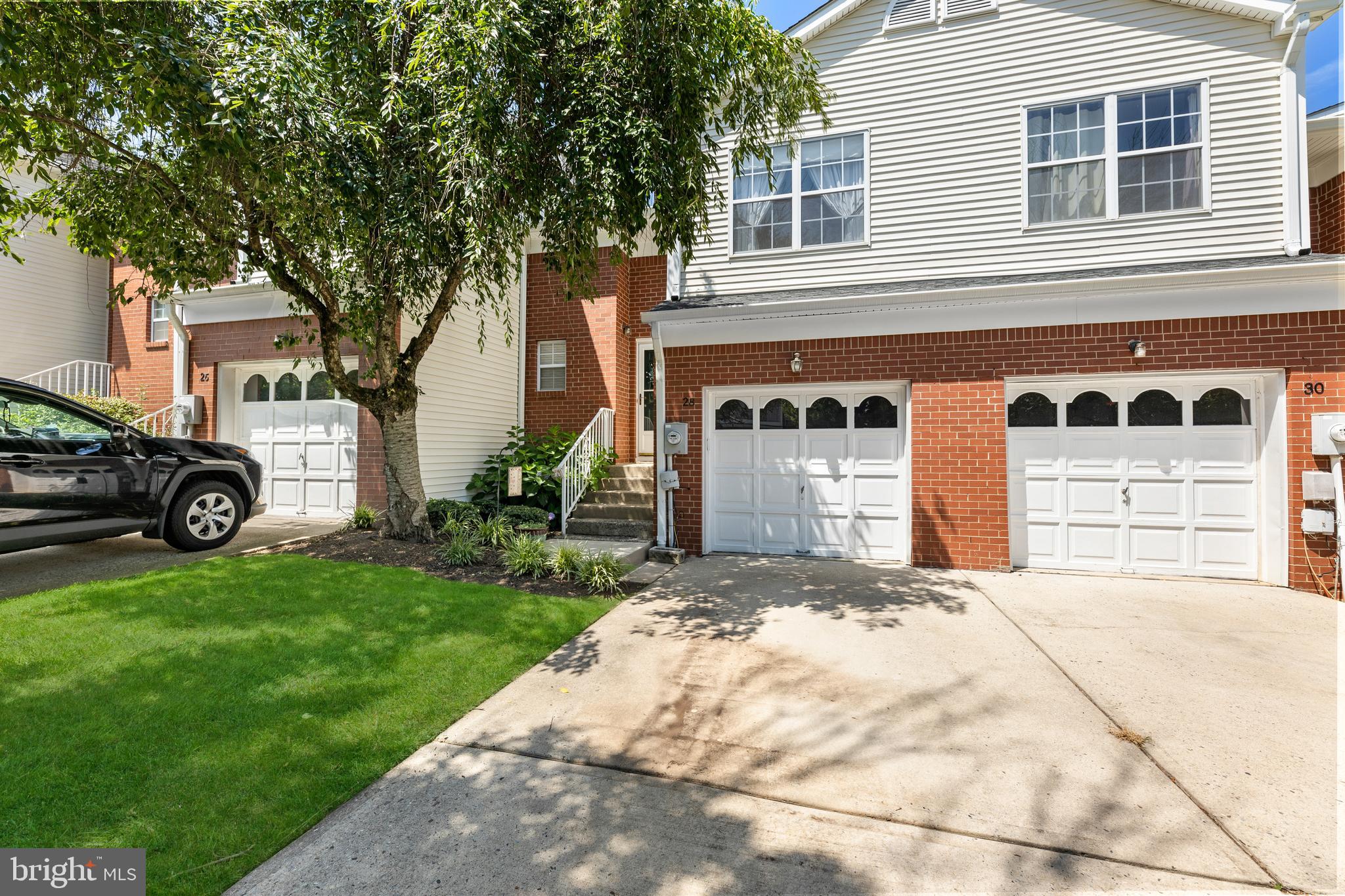 28 Garfield Way Princeton, NJ 08540 - Photo 2 of 38 a front view of a house with a yard and garage