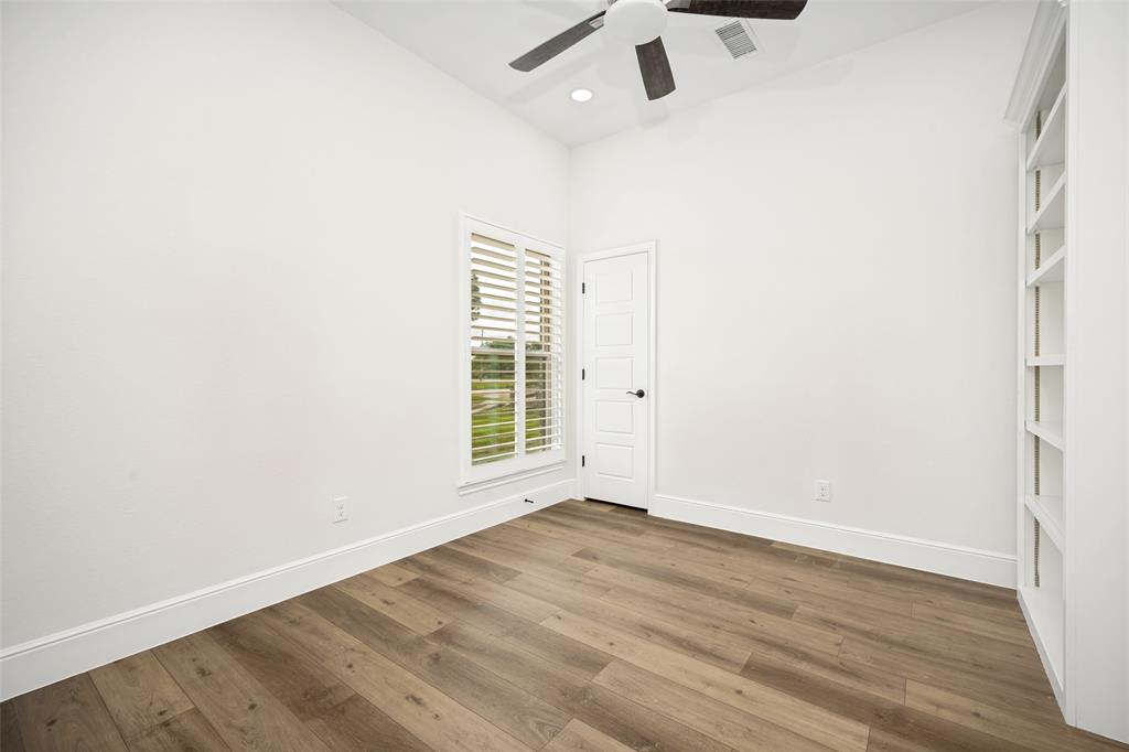 444 Ben Boyd Road Argyle, TX 76226 - Photo 14 of 28 an empty room with wooden floor fan and windows