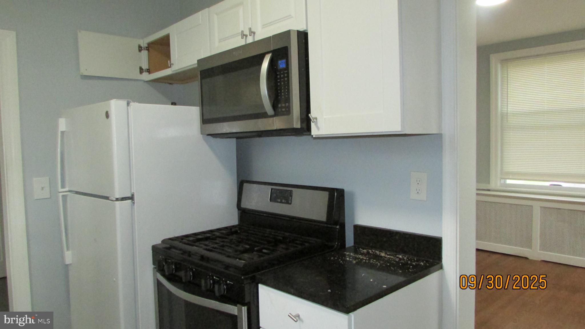 4501 Beechwood Road College Park, MD 20740 - Photo 11 of 57 a kitchen with granite countertop stainless steel appliances a stove a microwave and sink