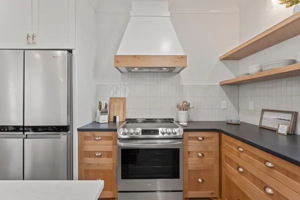 a kitchen with stainless steel appliances a stove and a refrigerator