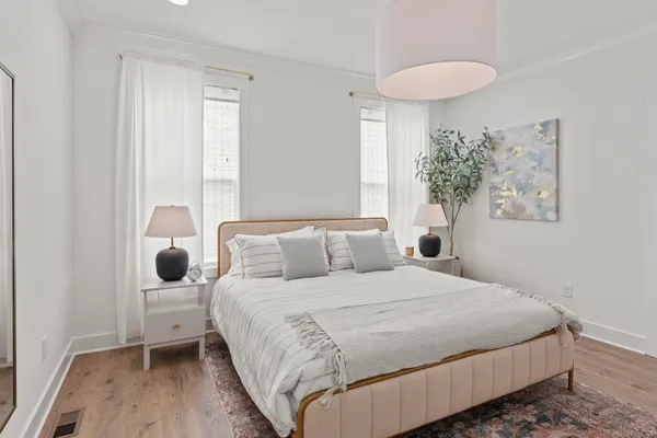 a bedroom with a bed and a window