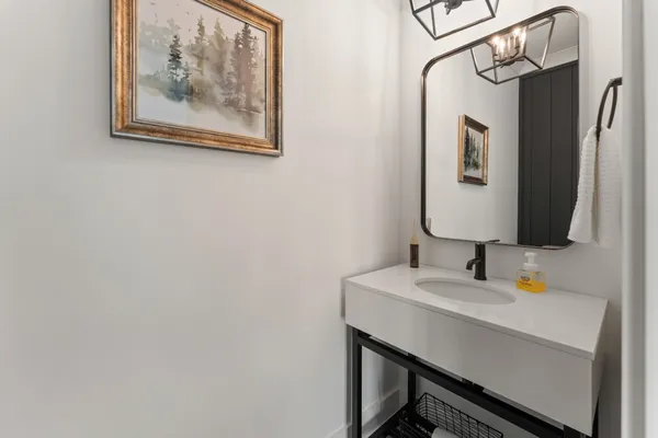 a bathroom with a sink a mirror and a toilet