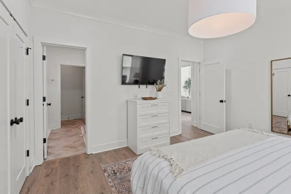 a bedroom with a bed and a flat screen tv