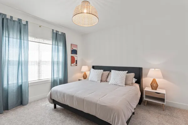 a bedroom with beds and a large window