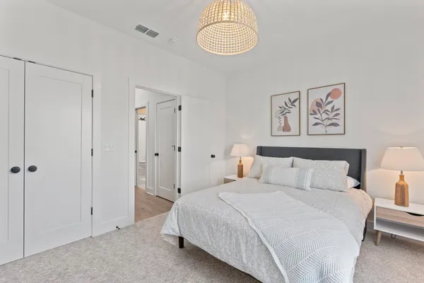 a bedroom with a bed and a chandelier