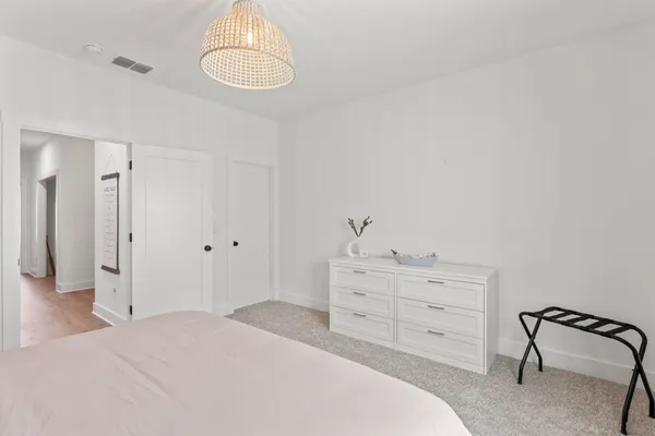 a bedroom with a bed and a dresser