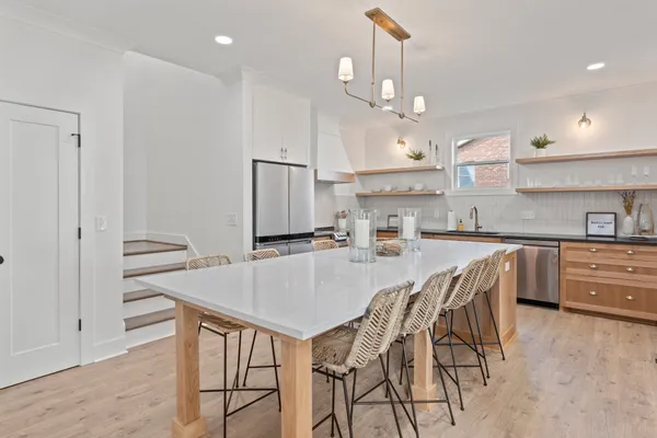 a large kitchen with a table and chairs