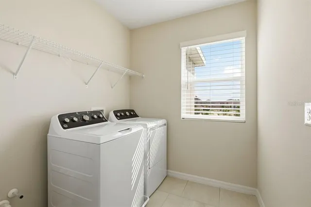a view of a pool a dinning table and chairs with wooden floor