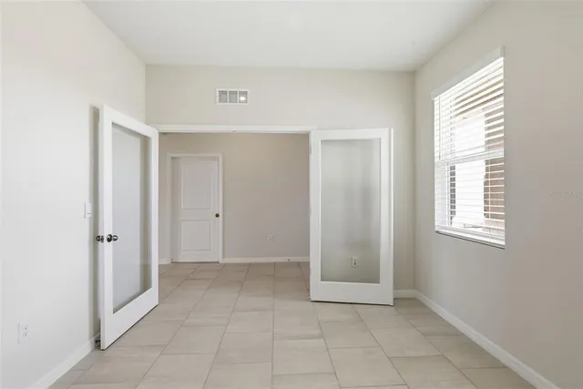 a kitchen with a sink a counter top space stainless steel appliances cabinets and a large window