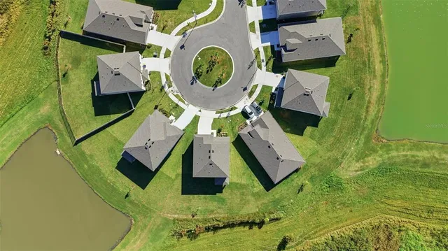 a view of a pool a dinning table and chairs with wooden floor