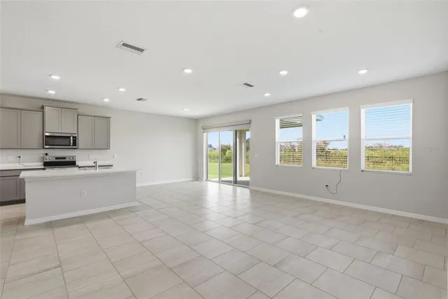 a kitchen with a sink a counter space appliances and cabinets