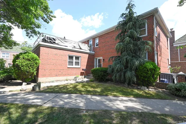 a backyard of a house with plants and trees