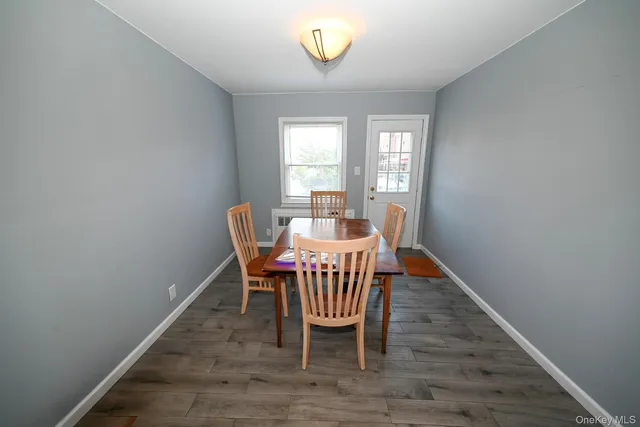 a dining room with furniture and a window