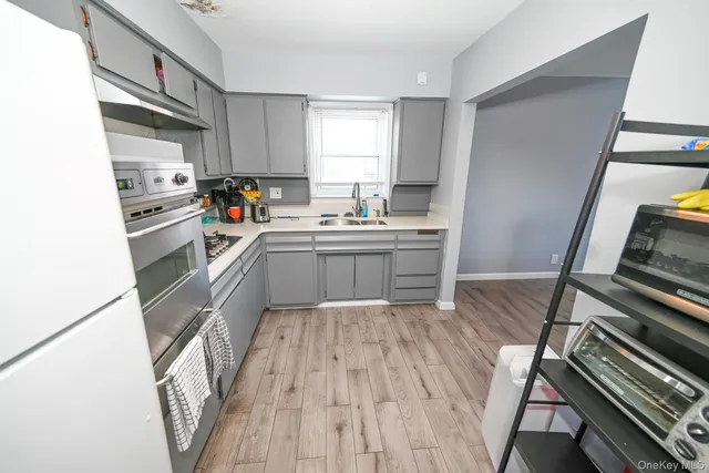 a kitchen with wooden floors and appliances