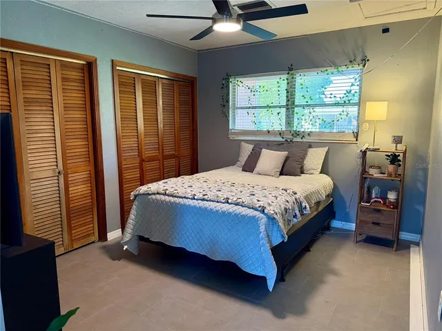 a bedroom with a bed and a large window