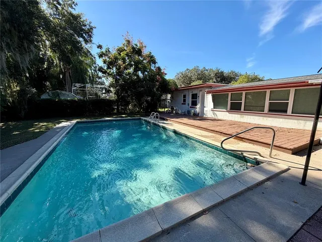 a view of a house with backyard and sitting area