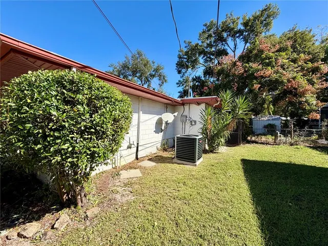 a view of a house with pool and sitting area