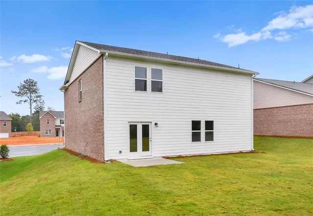 a view of a backyard with plants and a kitchen
