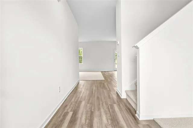 a view of a room with wooden floor