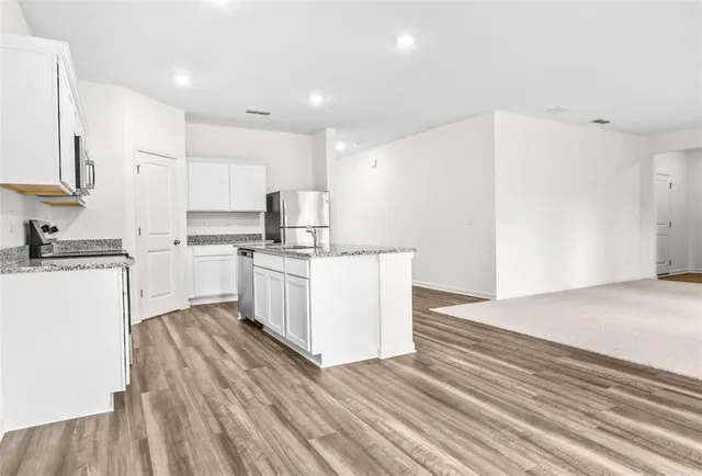 a kitchen with white cabinets and white appliances