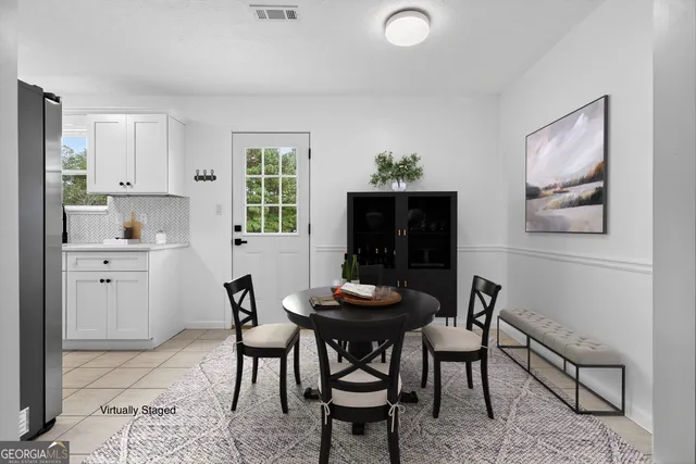 a dining room with furniture and window