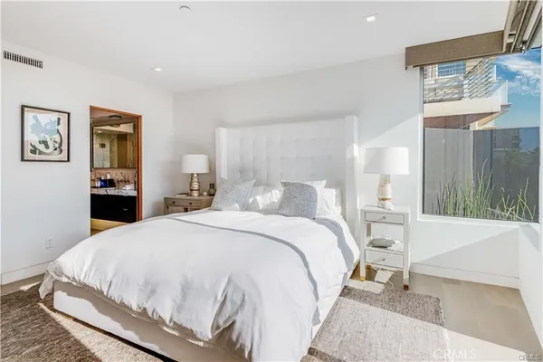 a bedroom with a bed and a dresser