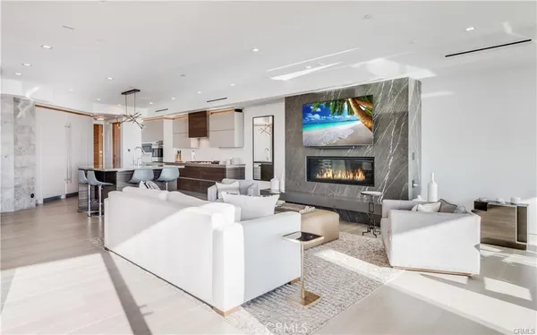 a living room with furniture a flat screen tv and a table