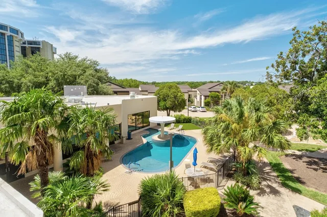 a view of a swimming pool and outside seating