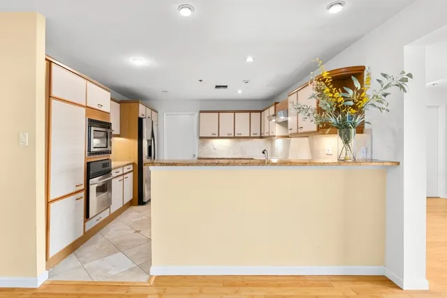 a kitchen with a sink cabinets and window
