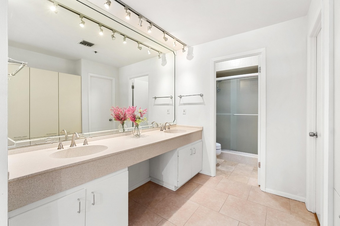 40 North Interstate Highway 35, Unit 3D3 Austin, TX 78701 - Photo 17 of 38 a bathroom with a double vanity sink mirror and double