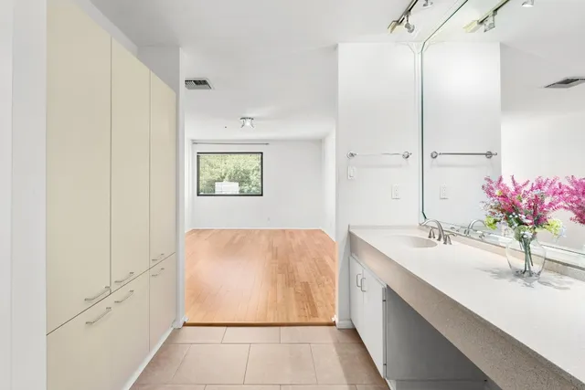 a white toilet sitting next to a shower