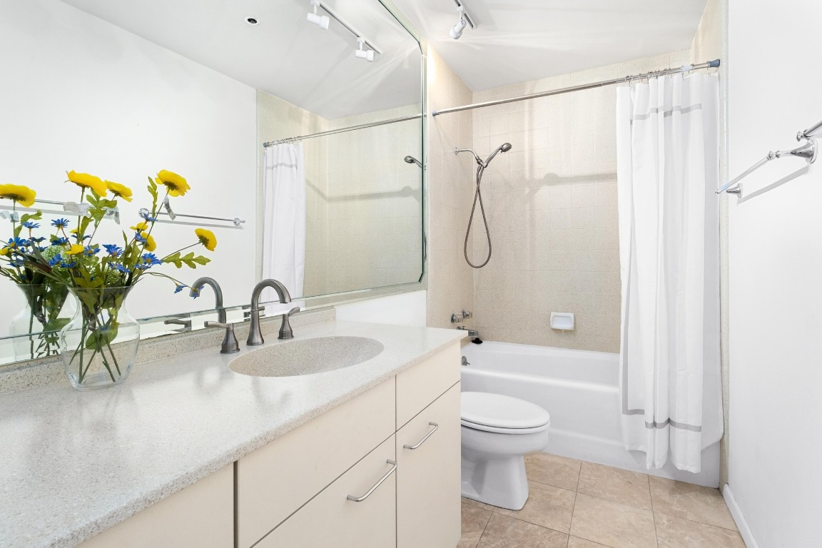 40 North Interstate Highway 35, Unit 3D3 Austin, TX 78701 - Photo 23 of 38 a bathroom with a granite countertop sink a toilet and shower