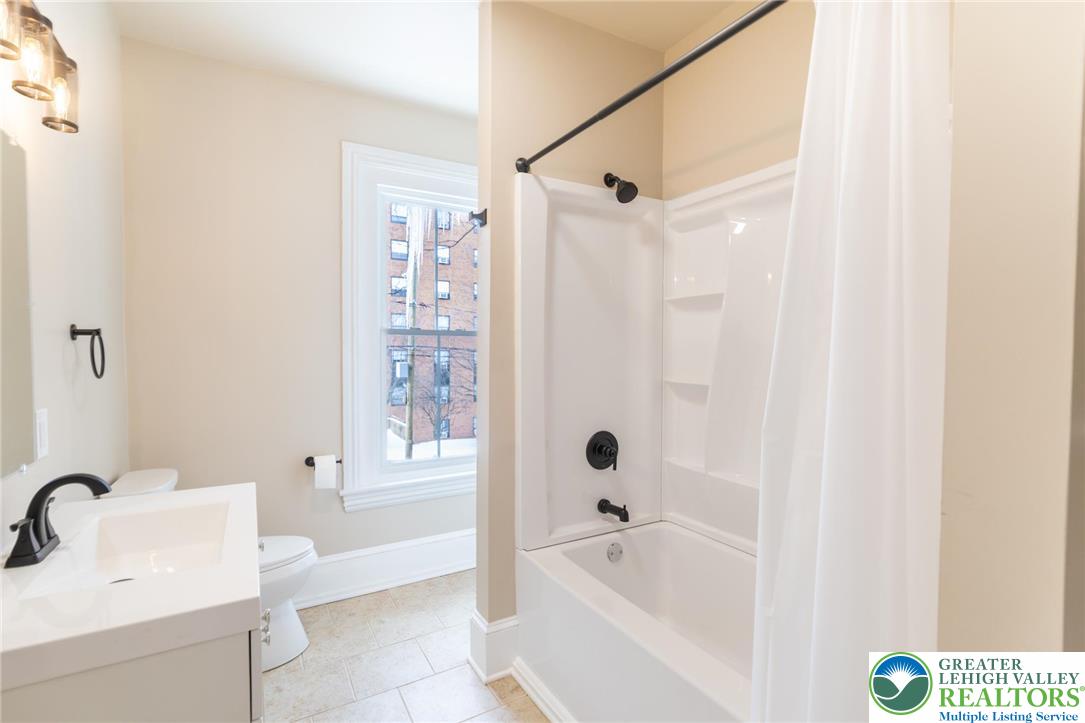 706 Main Street, Unit 2 Bethlehem, PA 18018 - Photo 13 of 20 a bathroom with a bathtub and a sink