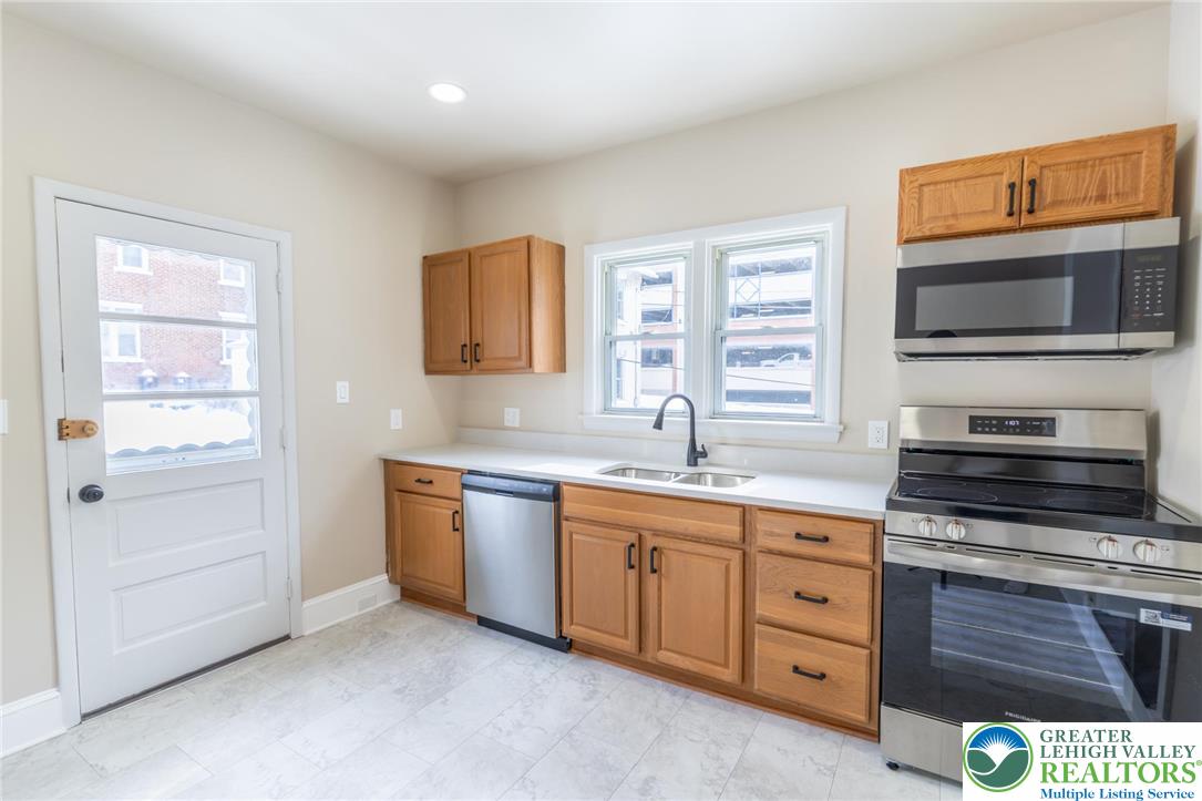 706 Main Street, Unit 2 Bethlehem, PA 18018 - Photo 17 of 20 a kitchen with stainless steel appliances a stove sink and microwave